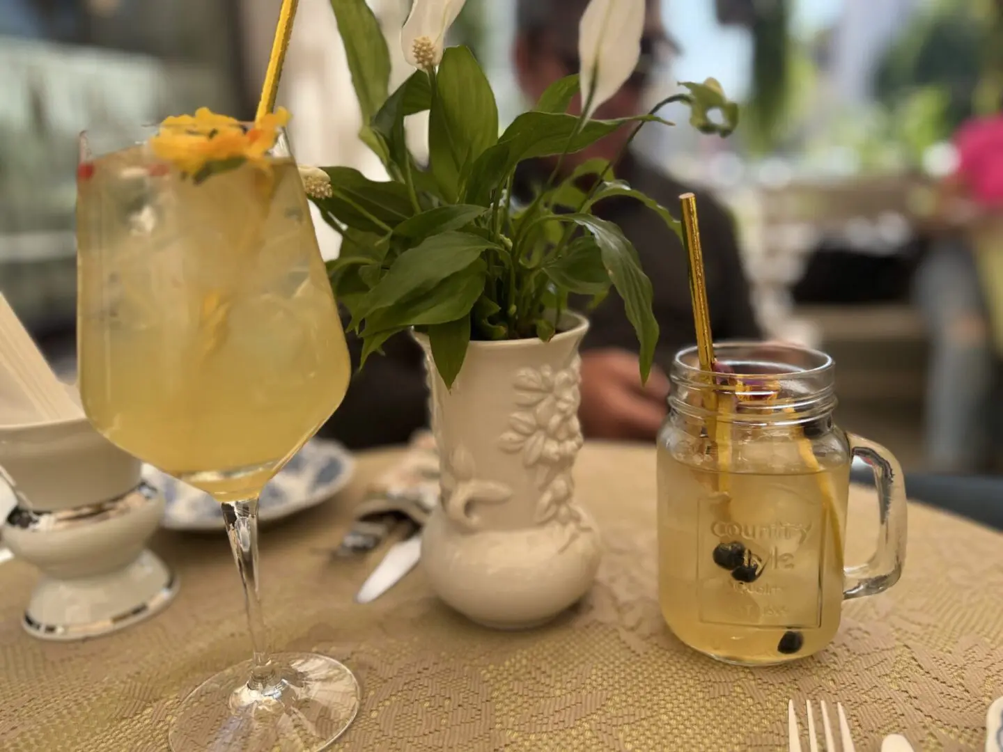 A table with two glasses and a jar of lemonade.